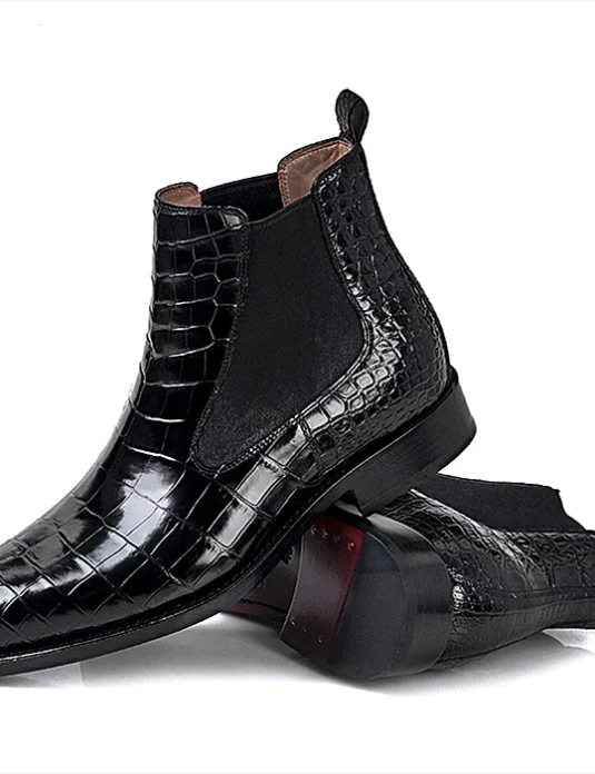Black alligator leather chelsea boots with crocodilian texture and elastic side panels