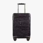 Schwarzer Koffer aus Alligatorleder mit vier 360°-Rollen und Teleskopgriff