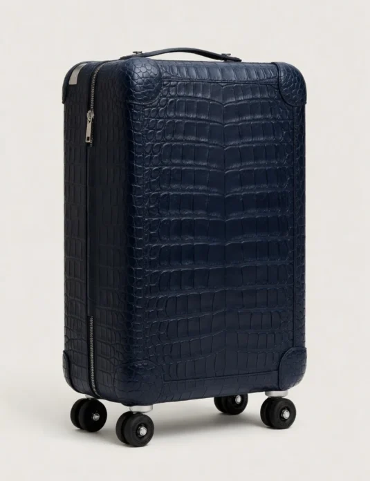Blue crocodile leather suitcase with four wheels and telescopic handle showing scaled texture pattern