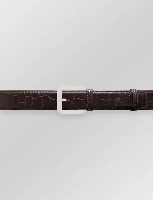 Brown alligator leather belt with silver buckle showing natural scaled texture and expert craftsmanship
