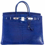 Blue crocodile handbag showing glossy crocodile leather texture with palladium hardware