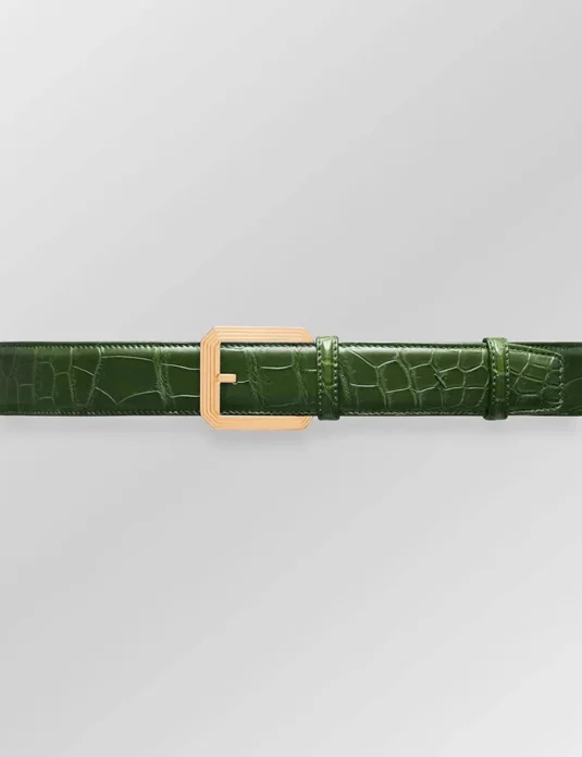Green alligator leather belt with gold buckle showing scaled texture and hand-stitched details