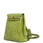 Green ostrich leather backpack with gold hardware showing textured exotic hide and adjustable straps