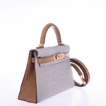 Grey alligator clutch bag with Kelly pochette design featuring brown leather trim and gold hardware