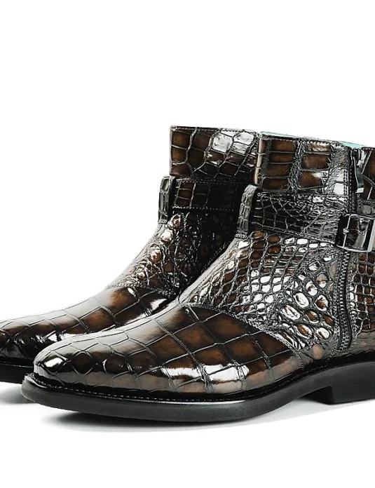 Brown alligator leather boots with lace-up design and buckle detail showing glossy scaled texture