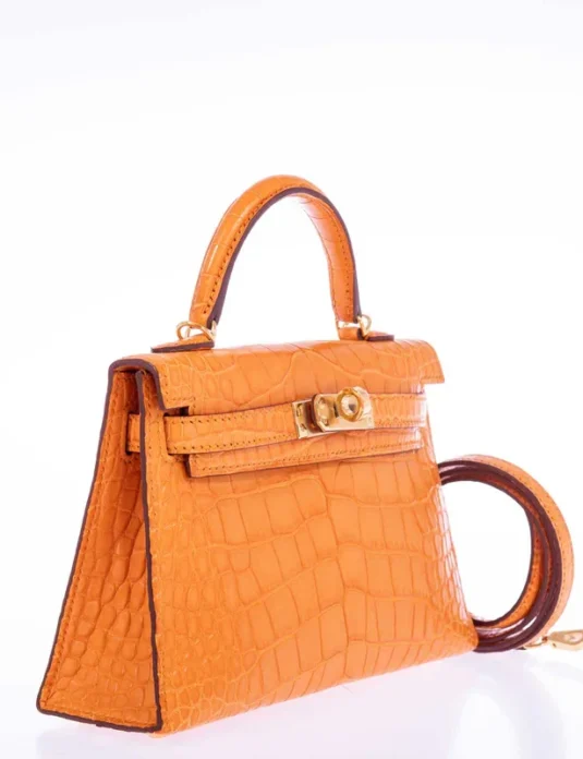 Orange alligator leather handbag Kelly style with gold hardware and structured silhouette