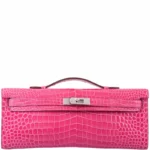 Pink crocodile clutch bag with diamond hardware showing Kelly Cut design and natural crocodile scaling