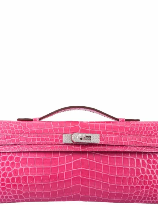 Pink crocodile clutch bag with diamond hardware showing Kelly Cut design and natural crocodile scaling