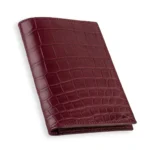 Red crocodile passport holder with burgundy scales and hand-stitched edges