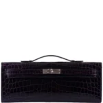 Purple crocodile leather clutch with glossy finish and top handle showing exotic scaled texture