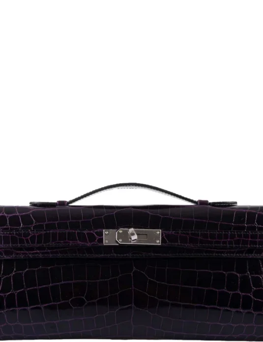 Purple crocodile leather clutch with glossy finish and top handle showing exotic scaled texture
