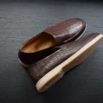 Brown crocodile leather loafers handcrafted with scaled texture and cream rubber soles