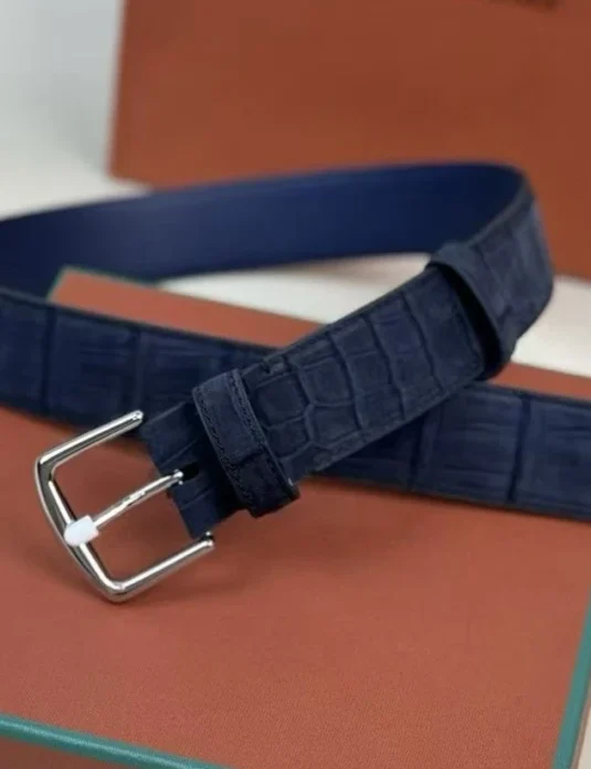 Dark blue crocodile leather belt with carbon nubuck finish and silver buckle on luxury packaging