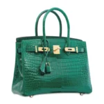 Green crocodile leather handbag with glossy finish and gold hardware in Birkin-style design