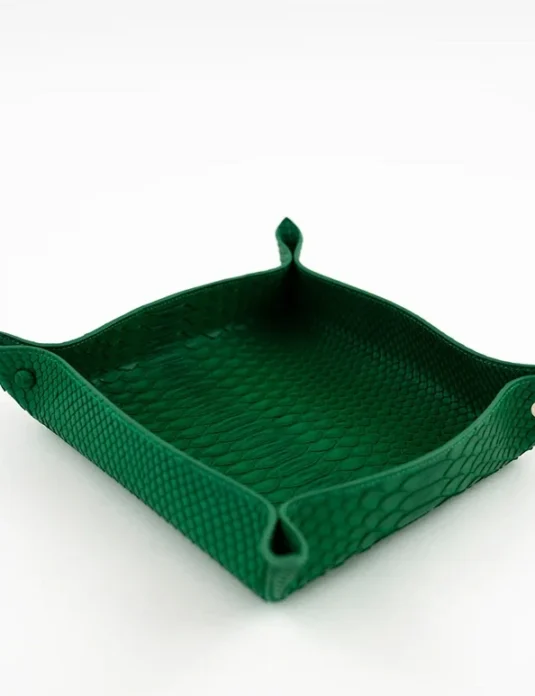 Green python leather tray with scaled texture and snap corner closures on white background