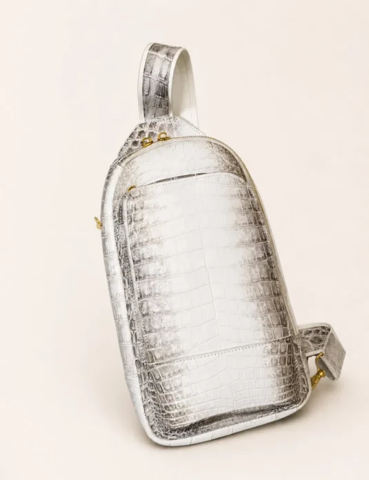 White crocodile leather sling bag with gold hardware showing Himalayan crocodile texture and adjustable strap
