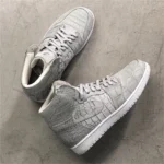 Gray crocodile leather sneakers in Jordan style showing detailed scale texture and white accents