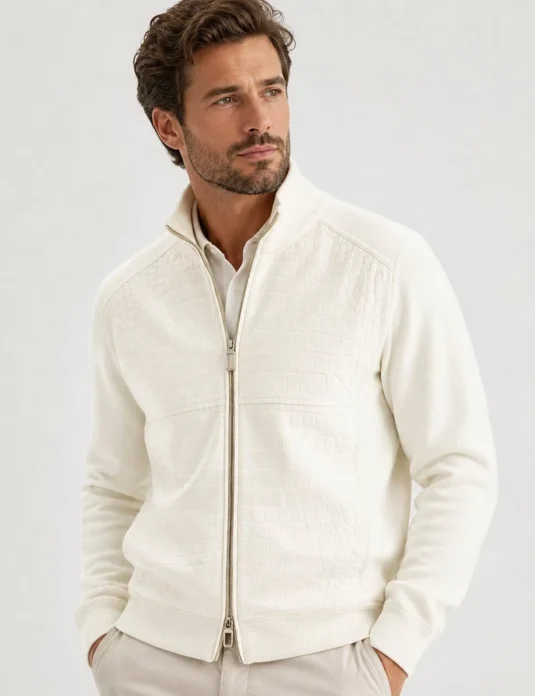 Ivory white crocodile bomber jacket worn by model showing textured leather exterior and ribbed trim details