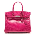 Pink crocodile leather handbag with glossy finish and Birkin-style design showing front view