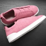 Pink crocodile sneakers in nubuck leather with distinctive scale pattern and white sole