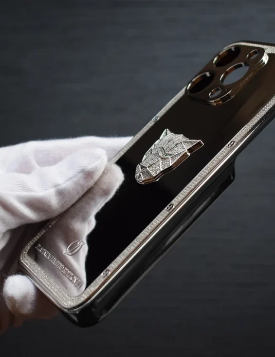 Silver panther phone case with metallic finish and diamond detailing held in white gloved hand