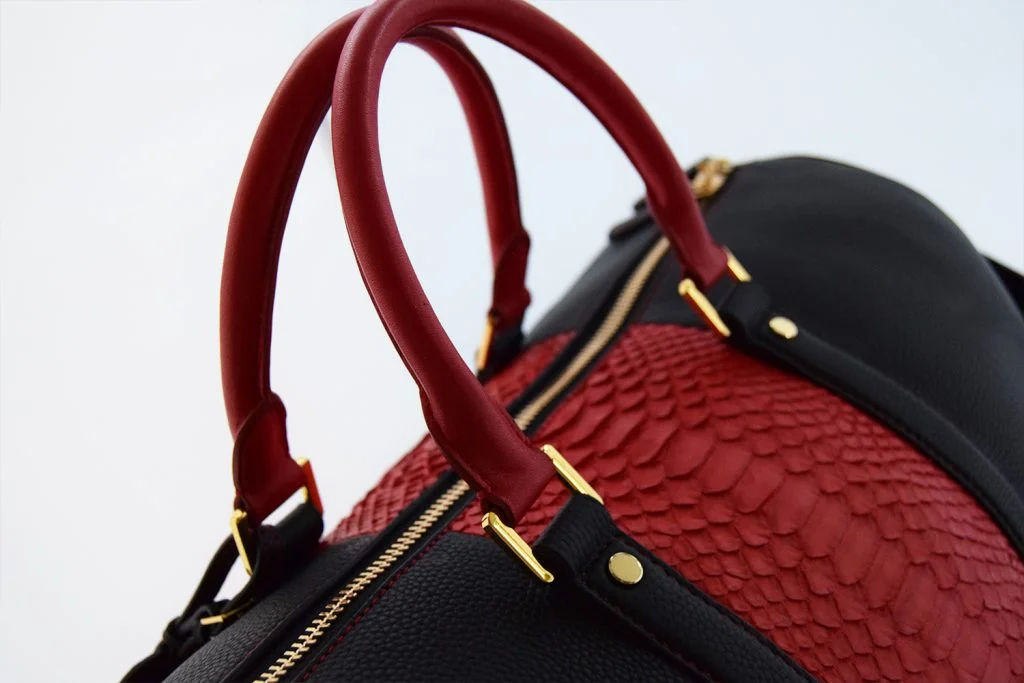 togo with red python duffle bag