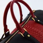 Togo with red python duffle bag