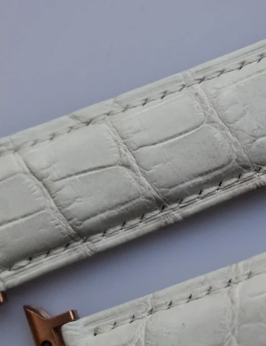 White crocodile apple watch band with rose gold butterfly clasp showing textured leather scales