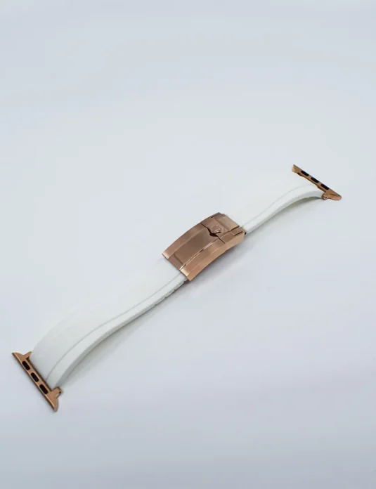 White leather apple watch band with rose gold buckle and curved design on white background
